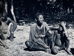 This River Bushman mother, a member of the primitive Xanekwe tribe, and her children were the first human beings we came across in seven days of cruising through the Okavango Swamps. We gave them tobacco and salt, sweets and trinkets. On the left is anoth